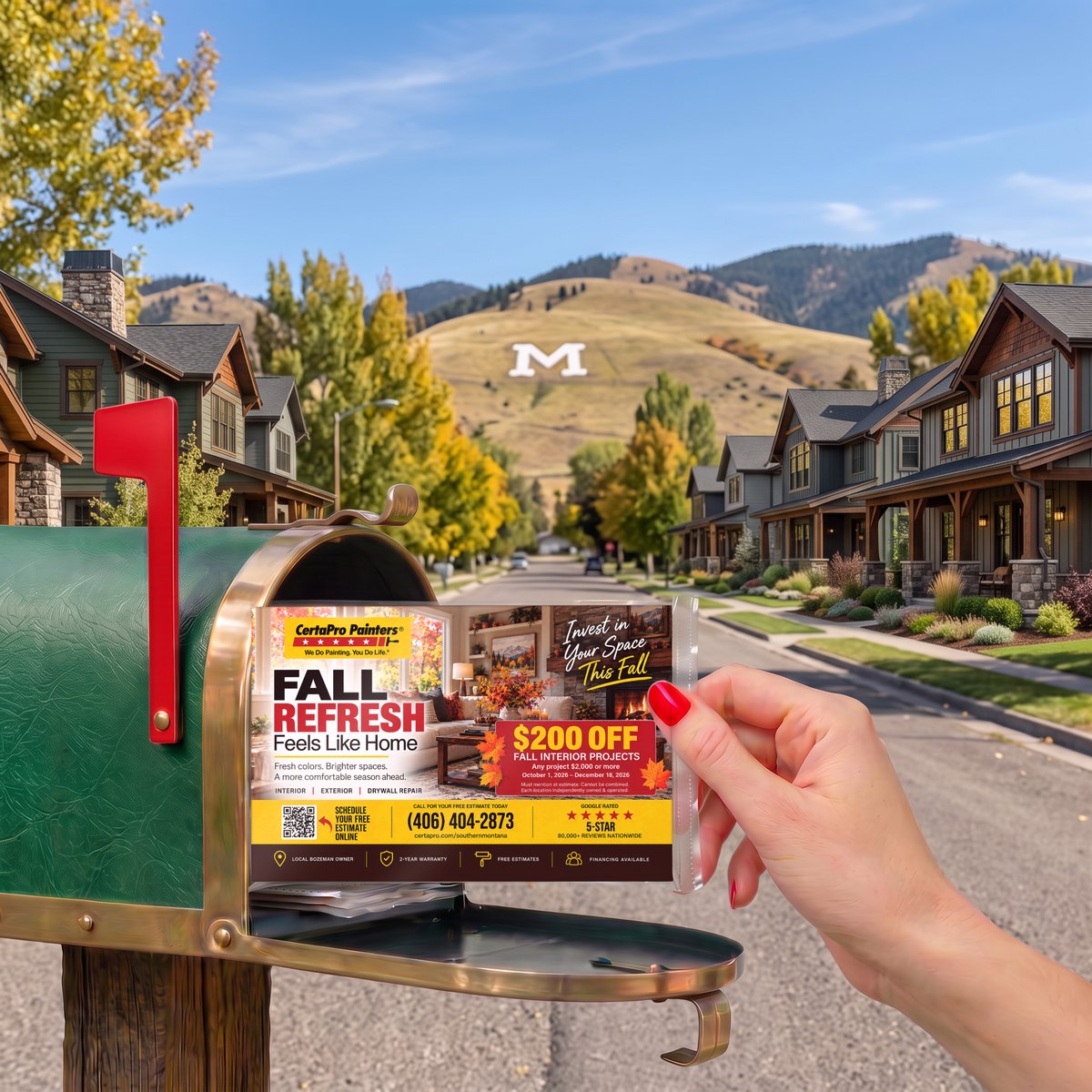 A hand pulling a Best in Business pack with a CertaPro Painters fall postcard from a mailbox on a Bozeman street, the white M on the Bridger foothills behind